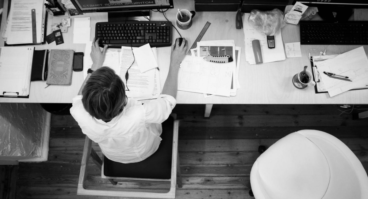 Hard work Man at desk with computer and papers