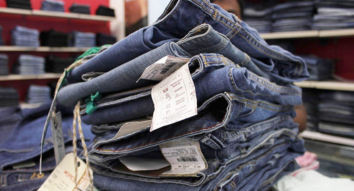 How are these made? Pile of denim jeans at a store