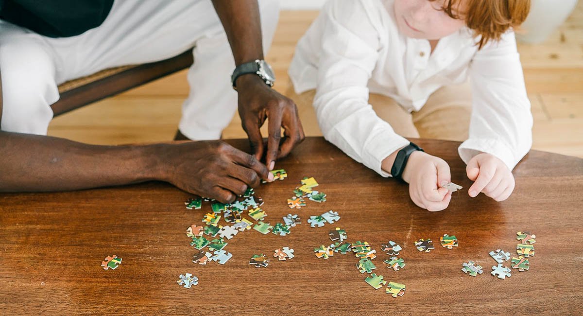 Put it all together Man and child putting puzzle together, diversity