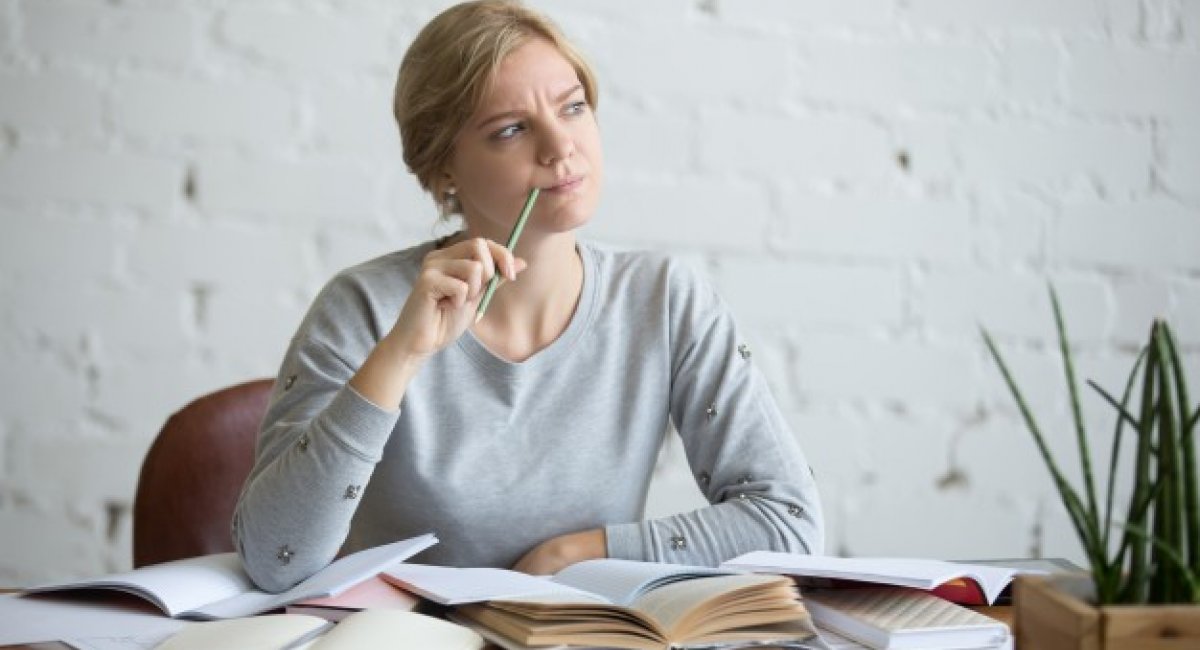 portrait student woman desk frowning