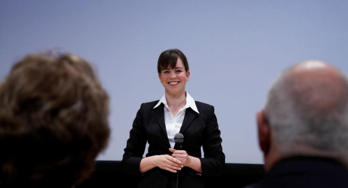 A businesswoman presenting on stage