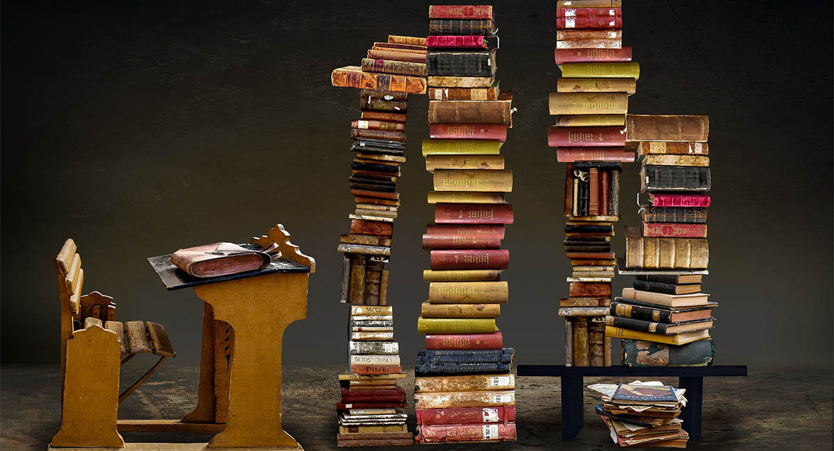 desk stacks of books dark color