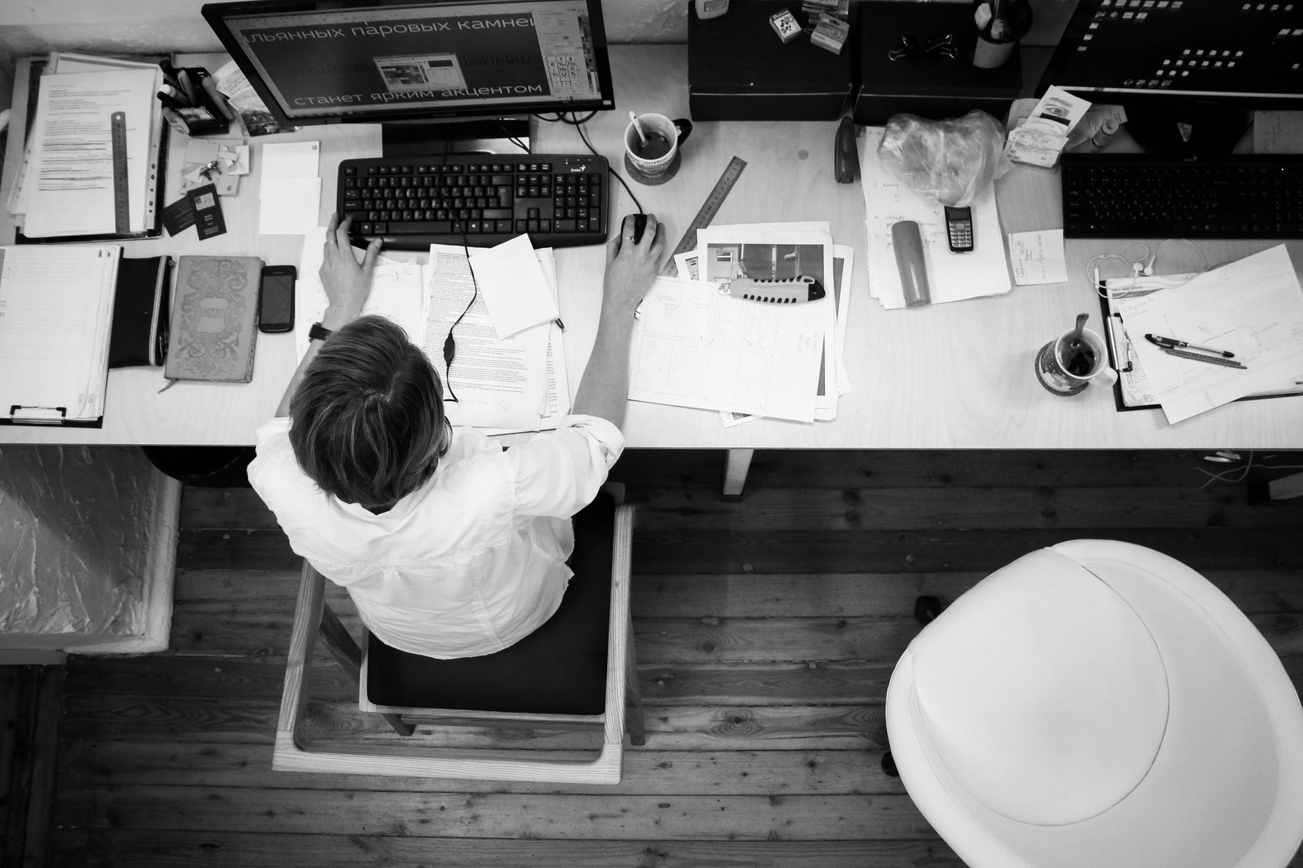 Man at desk with computer and papers