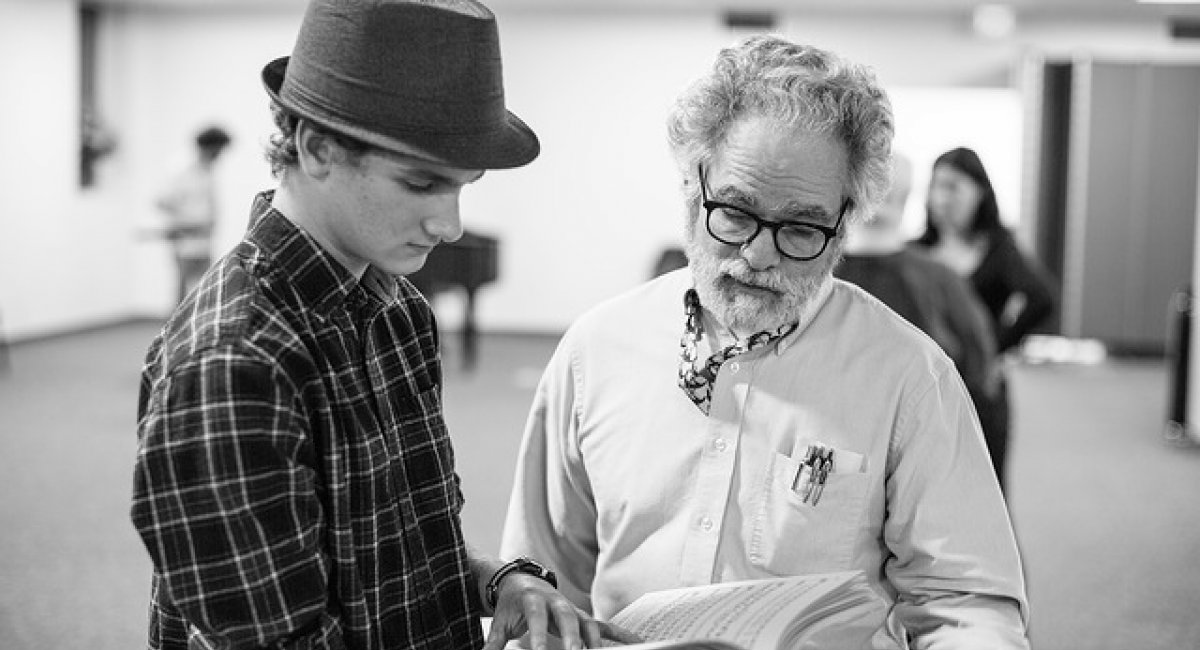 An older man coaching a younger man