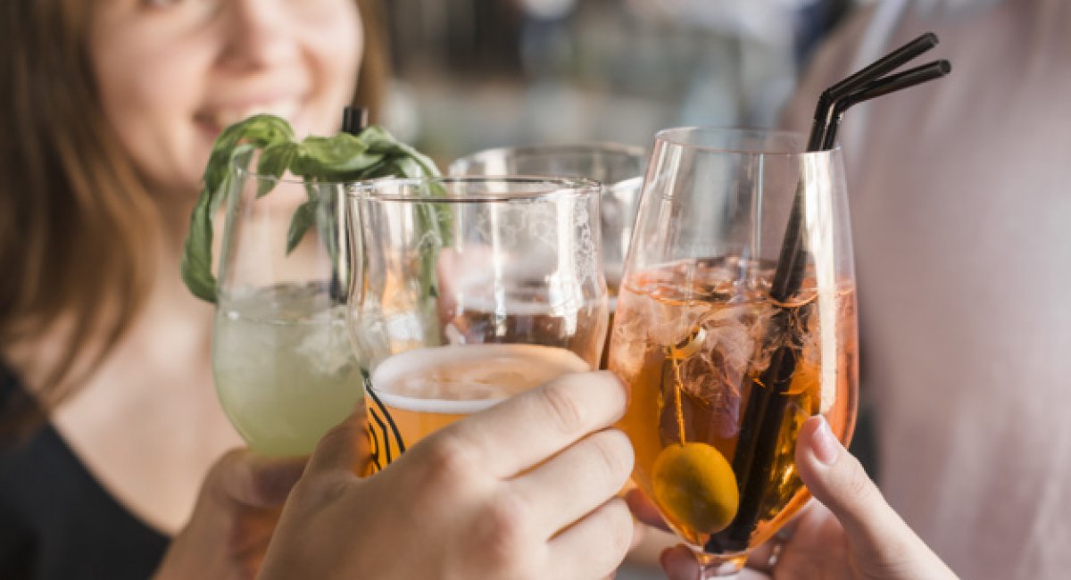 Close-up of friends toasting glasses of cocktails