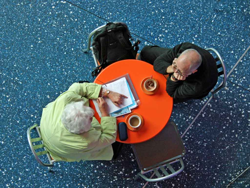 Two people talking at a small round table