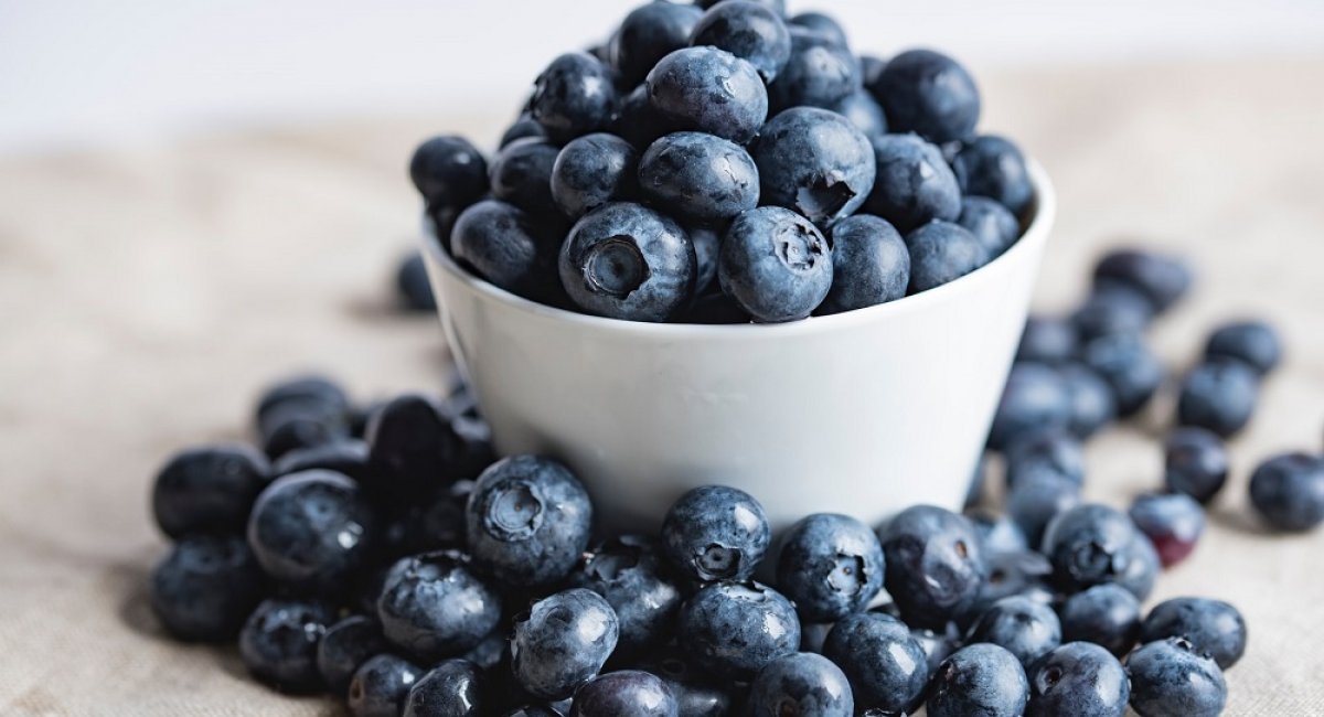 Blueberries overflowing a bowl