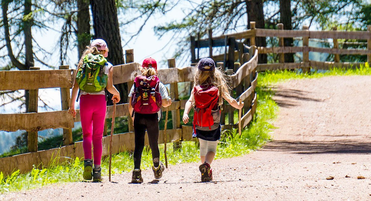 girls hiking forest path