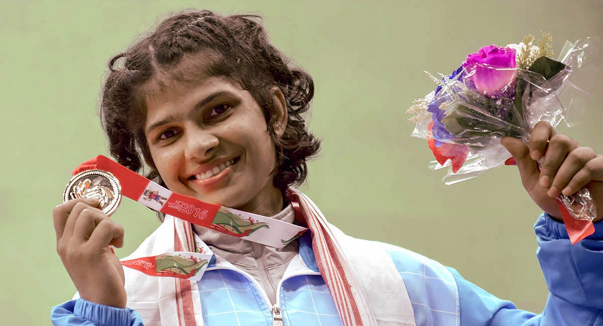 Young woman with winner's medal and flowers, Asian Indian
