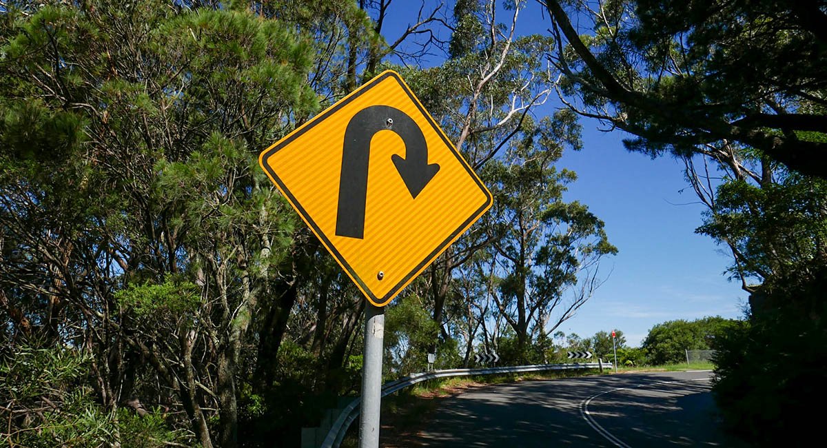 Road sign indicating sharp curve ahead