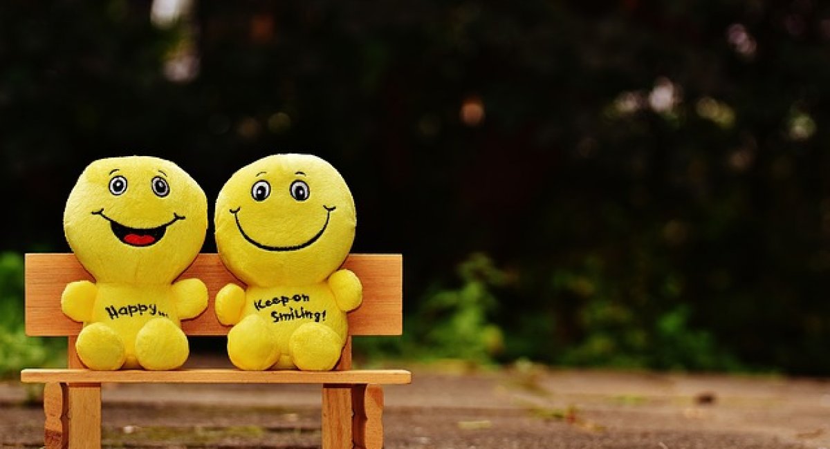 Two Smilies sitting on a bench